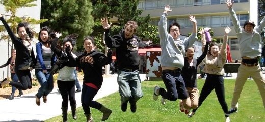 International student assistants jumping in the air