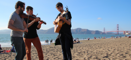 Students playing music on the beach