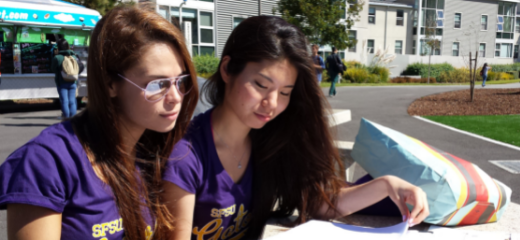 Two female students reading
