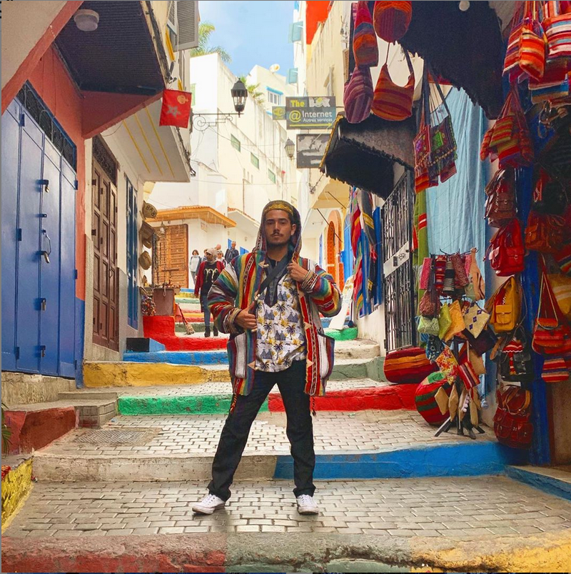 A student standing in front of a very colorful street