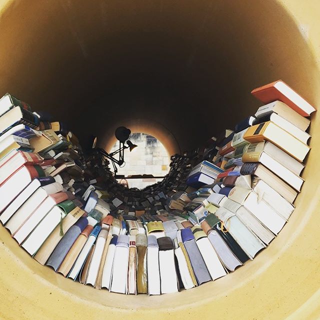 Lots of books stacked in a tube