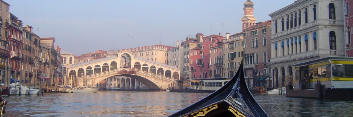 From the view of a gondola in Venice looking at a bridge
