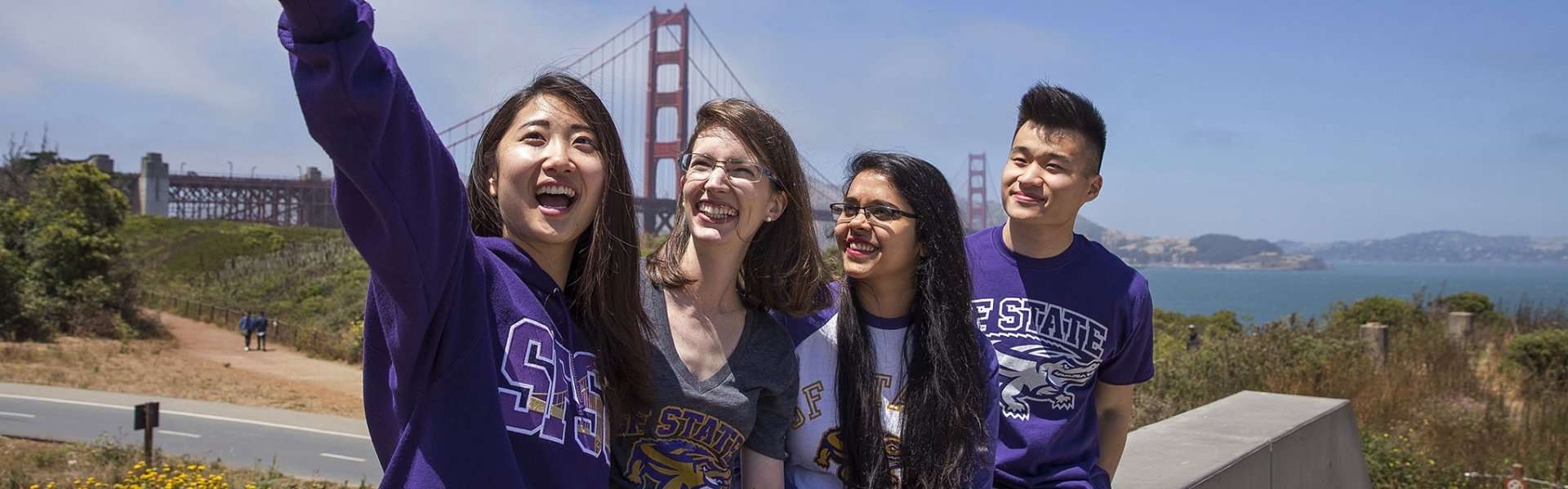 Four international students in front of the Golden Gate Bridge